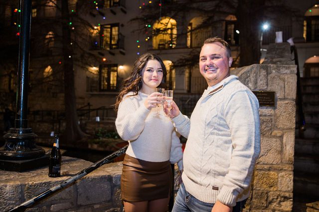 Ashlyn engagement in San Antonio on the bridge toasting with the champagne