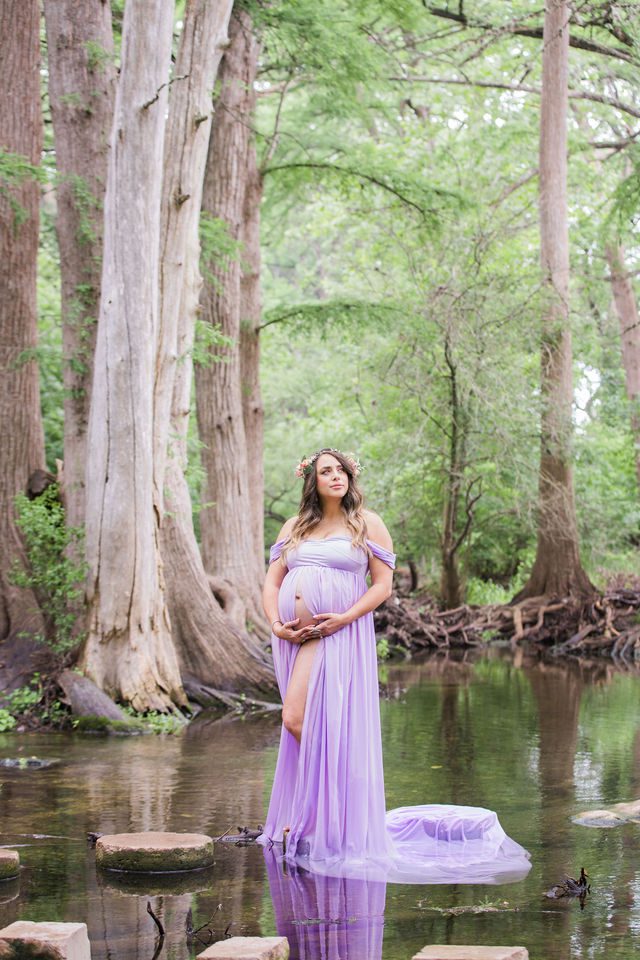 Yoli maternity session at Cibolo Natural Area in the water on the rounds looking up