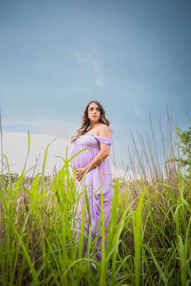 Yoli maternity session at Cibolo Natural Area mom looking up in the grass