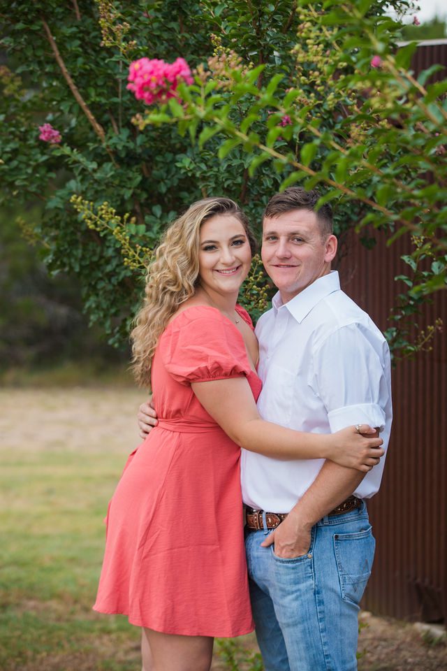 Brighten's engagement session at Western Sky in San Antonio in front of the barn and flowers
