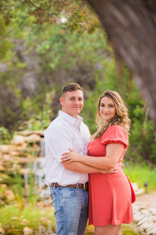 Brighten's engagement session at Western Sky in San Antonio portrait by waterfall