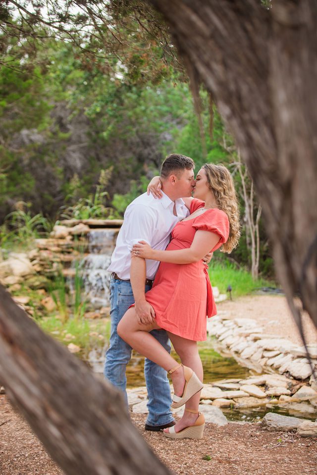 Brighten's engagement session at Western Sky in San Antonio kiss by waterfall