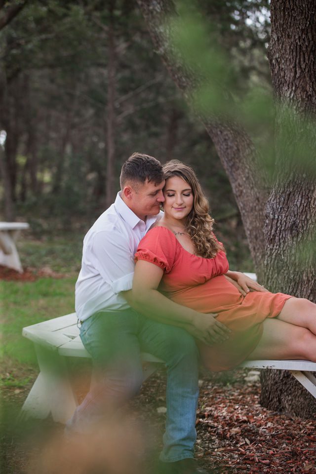 Brighten's engagement session at Western Sky in San Antonio thru the trees