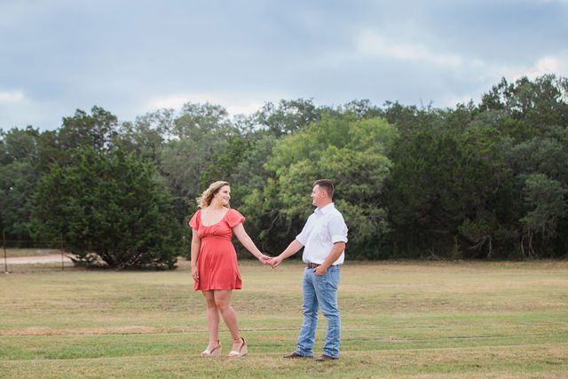 Brighten's engagement session at Western Sky in San Antonio in the field walking