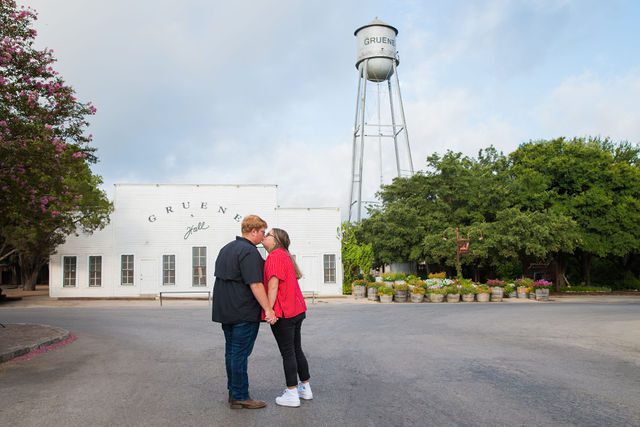 Ryanne engagement in Gruene kissing in front of the Hall