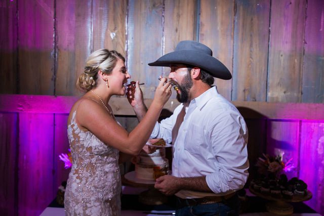 Kirt A's wedding reception at Eagle Dancer Ranch cake cutting eating