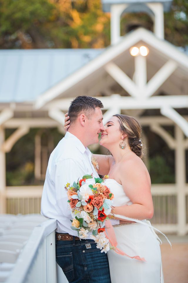 Brighten wedding at Western Sky bride and groom on bridge kiss