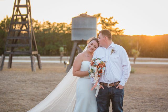 Brighten wedding at Western Sky couple at sunset kiss portrait