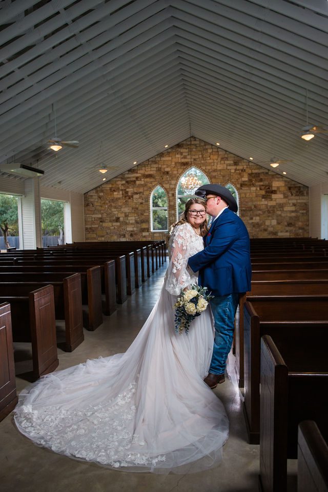 Ryanne's Wedding at the Chandelier of Gruene bride & groom inside chapel kiss