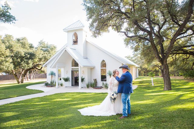 Ryanne's Wedding at the Chandelier of Gruene couple on the grass at the chapel