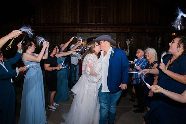 Ryanne's Wedding at the Chandelier of Gruene reception exit kiss